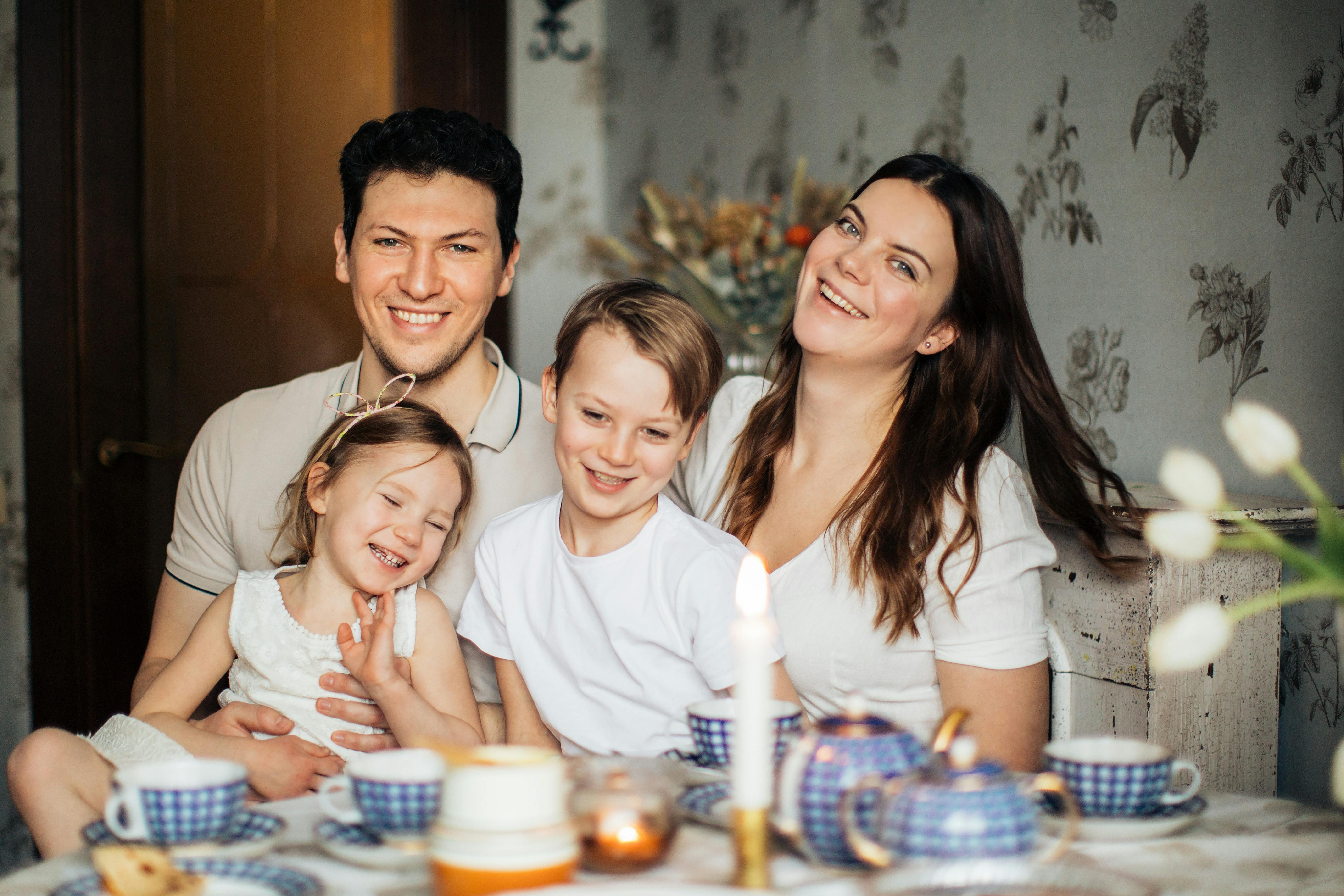 Mother sharing a meal with children, representing the invaluable childcare and household services that stay-at-home parents provide