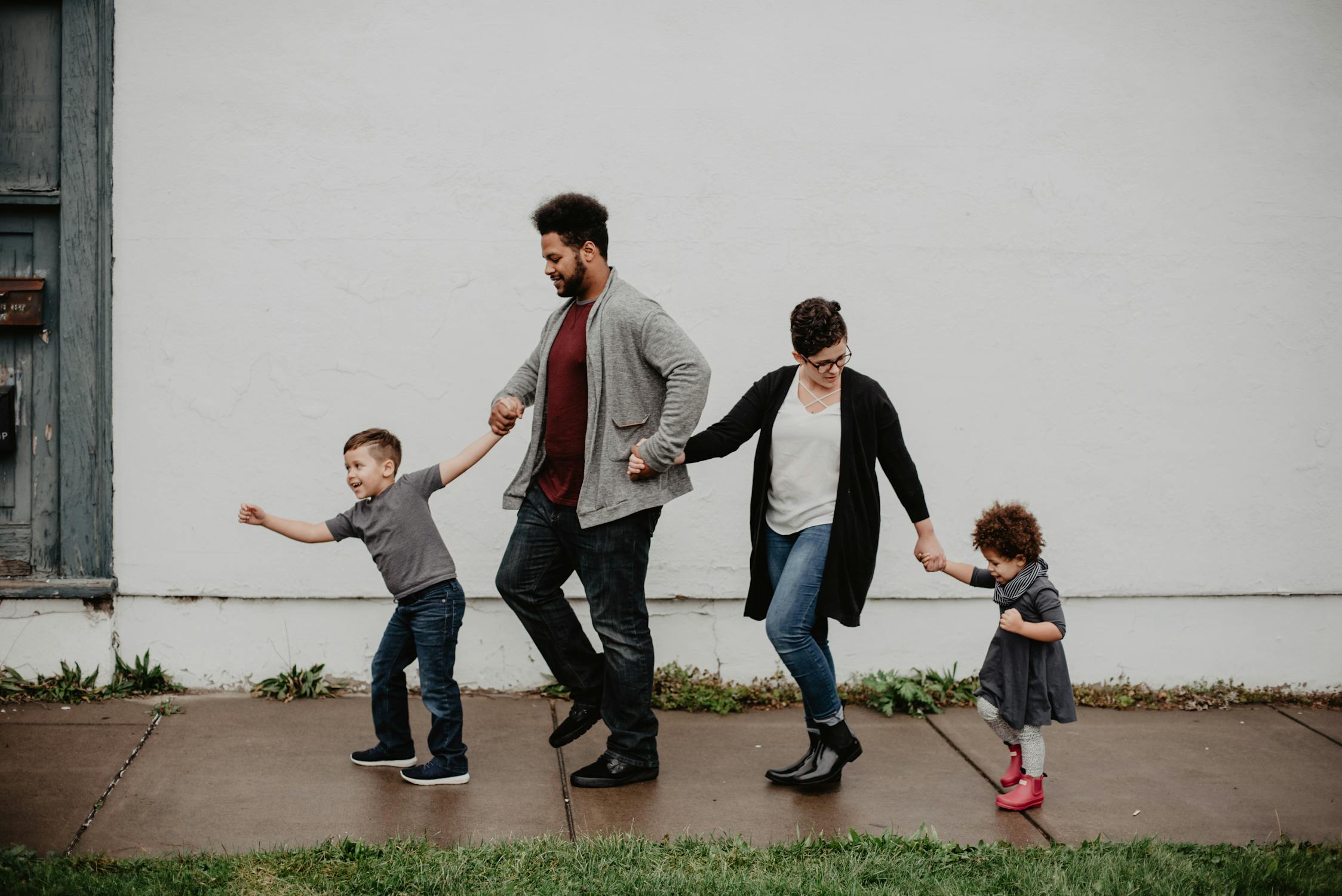 Florida family of four walking together hand-in-hand on a city street, representing couples weighing joint life insurance vs two individual policies