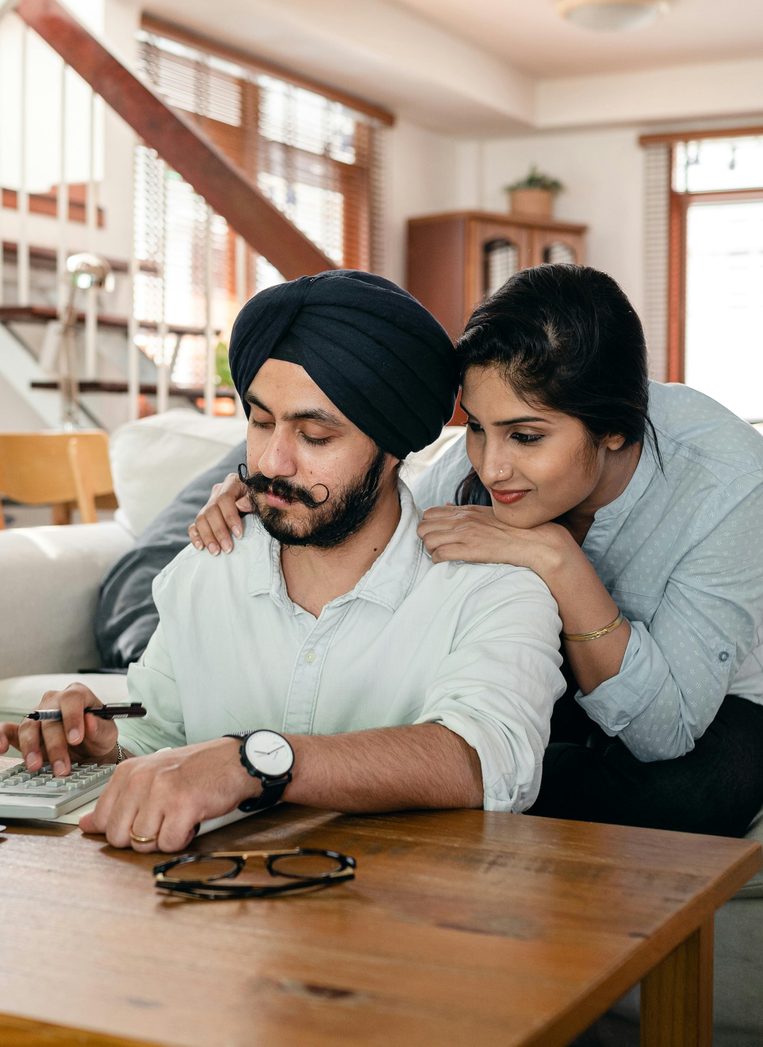 Florida couple at home reviewing finances together at the kitchen table — running a private banking strategy with their whole life policy